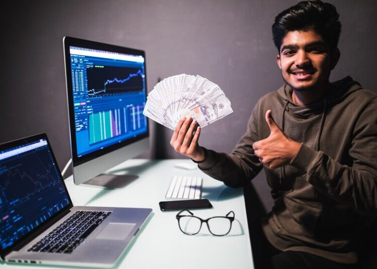 make money online angelic rich businessman with nimbus head pointing dollar banknotes encouraging earn internet sitting laptop workplace indoor studio shot isolated white background 231208 3660